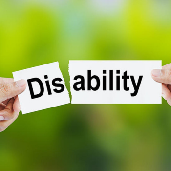 Two hands tearing a piece of paper with the word "Disability" written on it, against a green background.